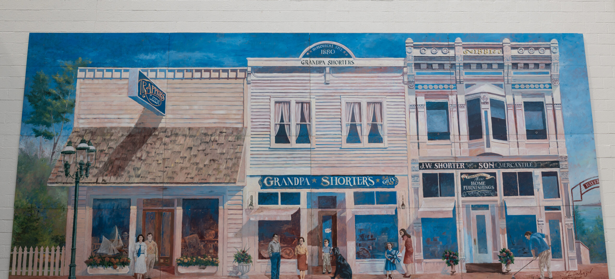 Mural depicts store three storefronts, arching red sign to 'Bayfront Park', gas light lamps, and various people walking about