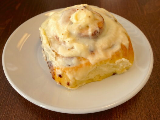 large cinnamon roll with icing on top