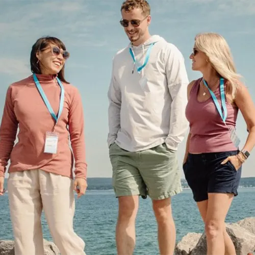 Meetings Group Events A group of people walking by the beach