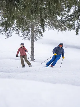 Two people skiing in the snow
