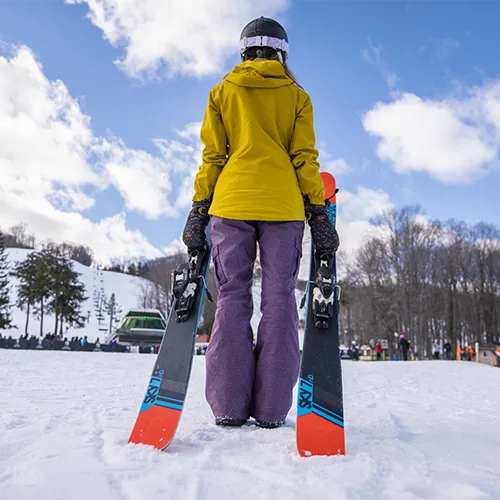 A person holding skis